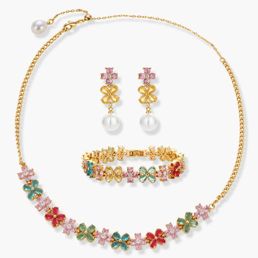 Gold-plated jewelry set with pink, turquoise and red flower-shaped cubic zirconia stones, featuring necklace, earrings and bracelet.