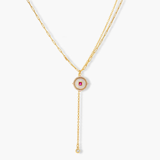 Gold-plated circular medallion necklace set with white enamel base and pink cubic zirconia accent stones
