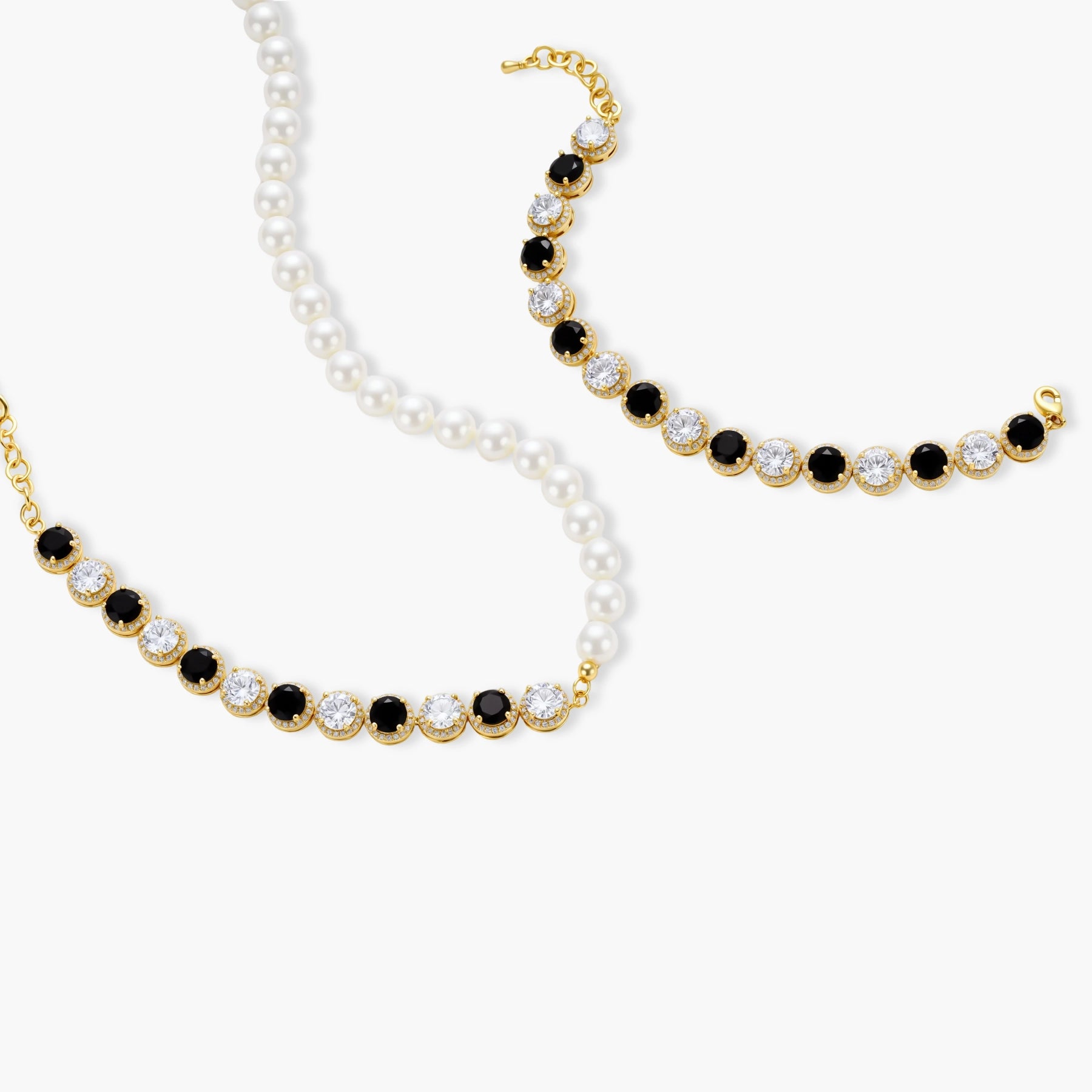 Gold-plated jewelry set with alternating black and clear cubic zirconia stones, featuring necklace, earrings and bracelet