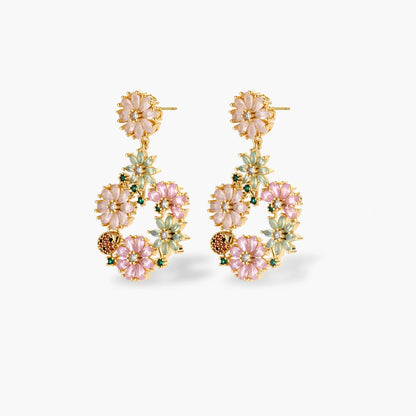 14K gold plated jewelry set with pink and green cubic zirconia flowers arranged in wreath design on cream background