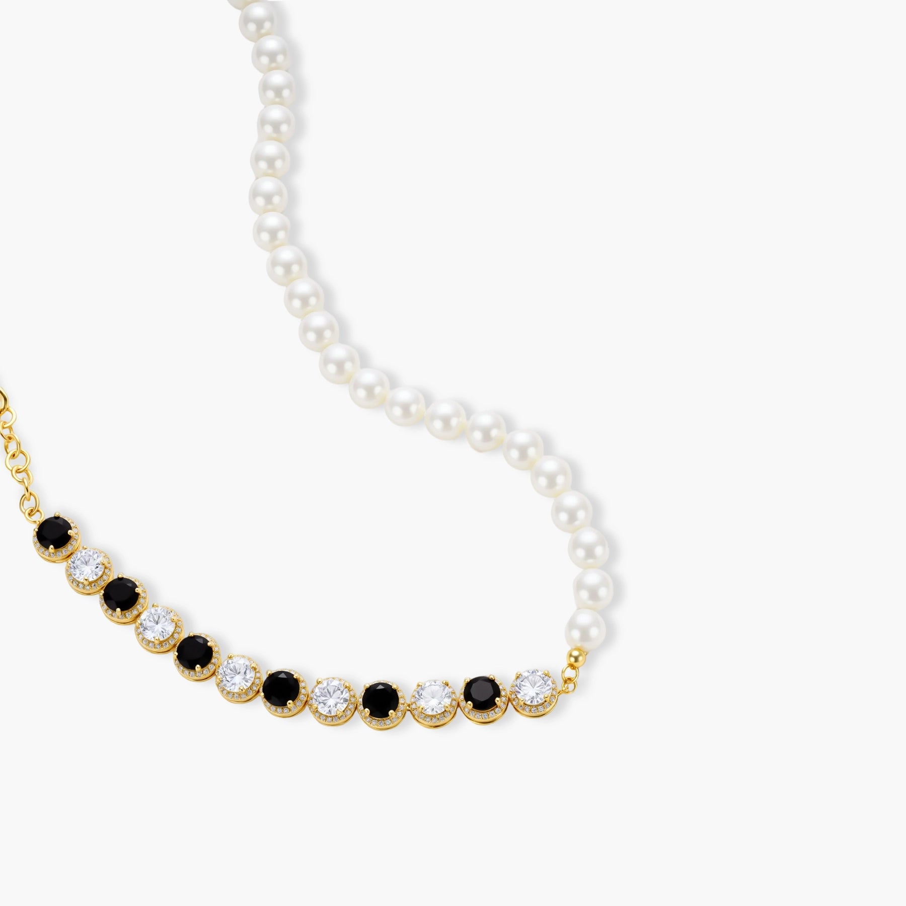 Gold-plated jewelry set with alternating black and clear cubic zirconia stones, featuring necklace, earrings and bracelet