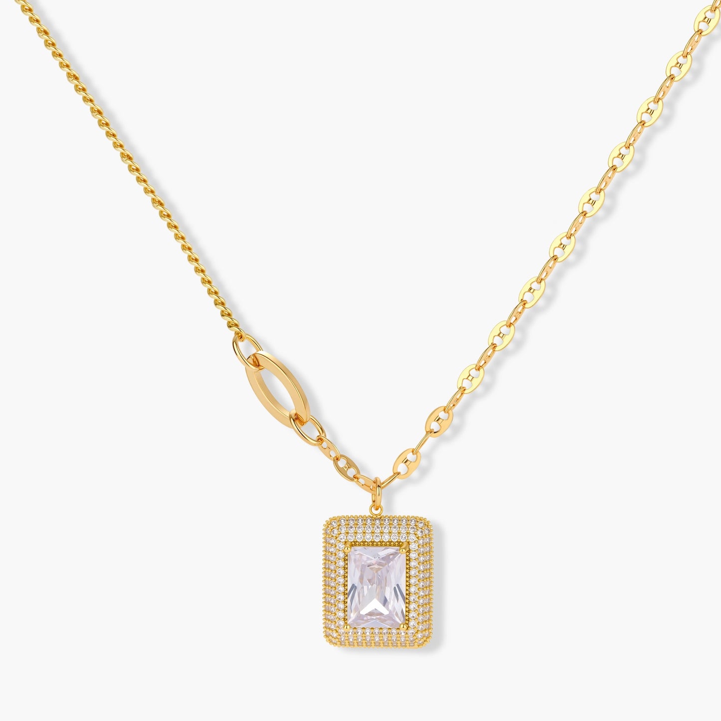 Gold-plated jewelry set with rectangular cubic zirconia stones in pave halo settings on cream background