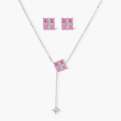 White gold plated jewelry set with pink cubic zirconia stones in geometric cross design, featuring Y-necklace and square stud earrings