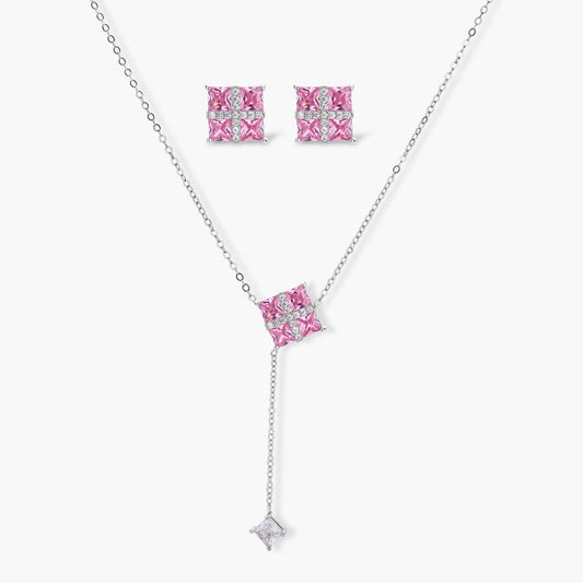 White gold plated jewelry set with pink cubic zirconia stones in geometric cross design, featuring Y-necklace and square stud earrings