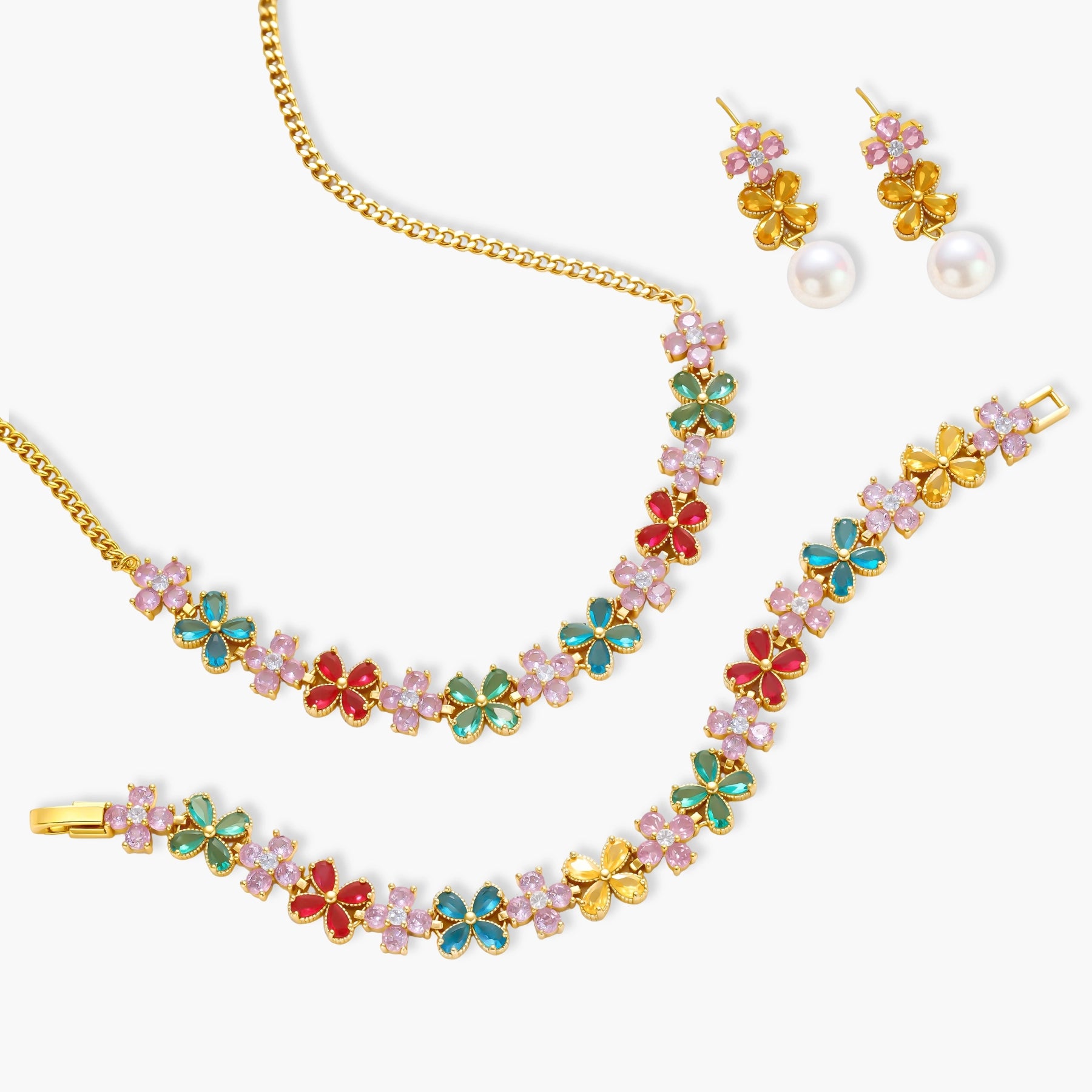 Gold-plated jewelry set with pink, turquoise and red flower-shaped cubic zirconia stones, featuring necklace, earrings and bracelet.