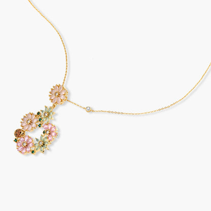 14K gold plated jewelry set with pink and green cubic zirconia flowers arranged in wreath design on cream background