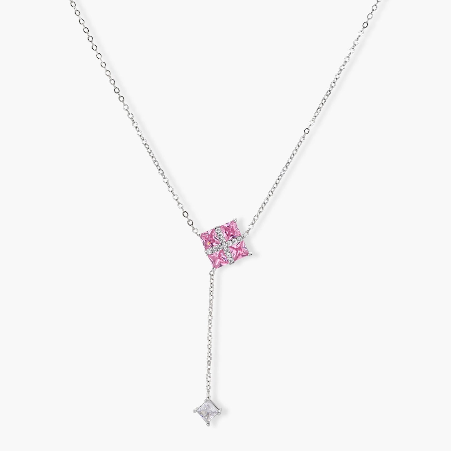 White gold plated jewelry set with pink cubic zirconia stones in geometric cross design, featuring Y-necklace and square stud earrings