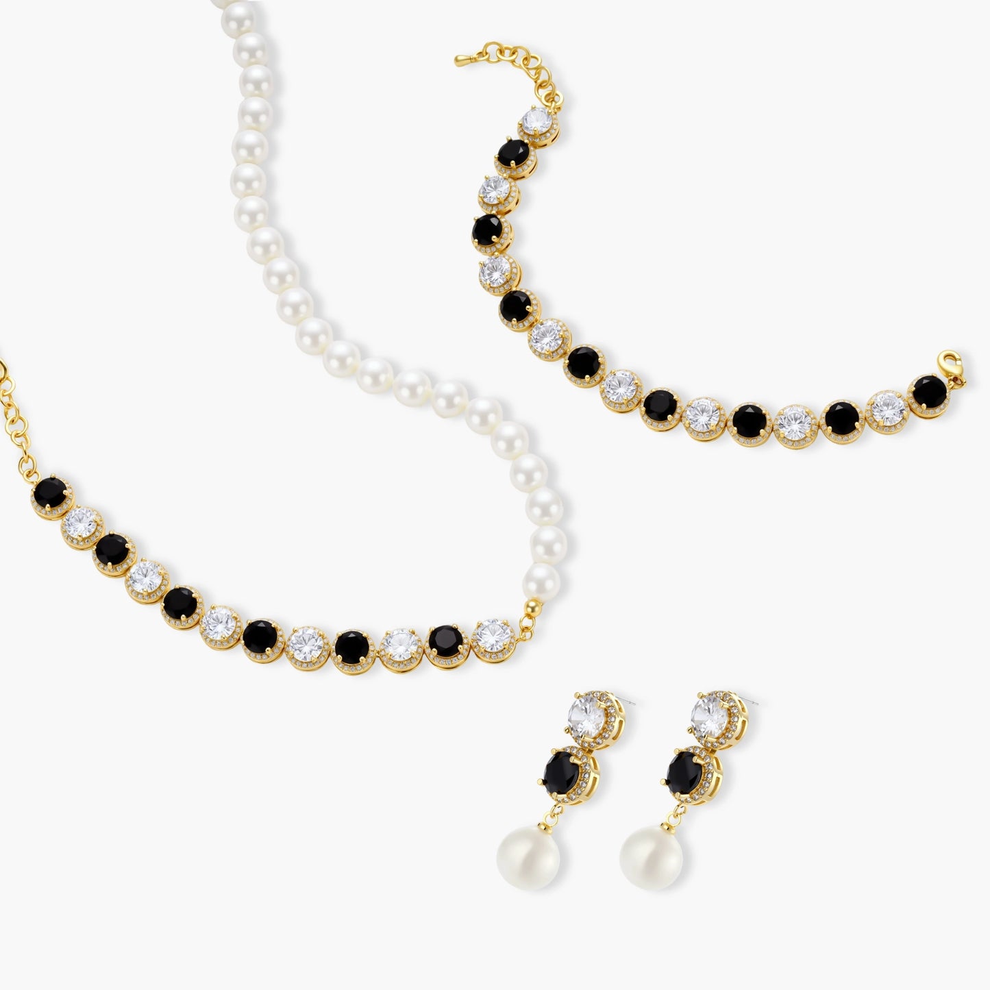 Gold-plated jewelry set with alternating black and clear cubic zirconia stones, featuring necklace, earrings and bracelet