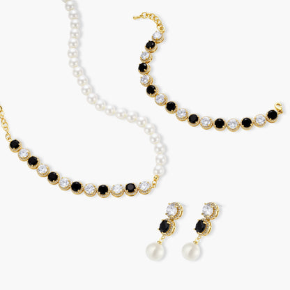 Gold-plated jewelry set with alternating black and clear cubic zirconia stones, featuring necklace, earrings and bracelet