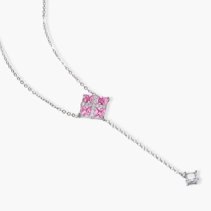 White gold plated jewelry set with pink cubic zirconia stones in geometric cross design, featuring Y-necklace and square stud earrings