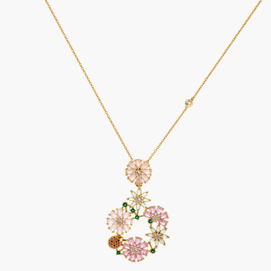 14K gold plated jewelry set with pink and green cubic zirconia flowers arranged in wreath design on cream background