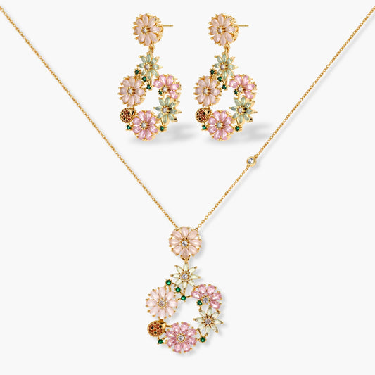 14K gold plated jewelry set with pink and green cubic zirconia flowers arranged in wreath design on cream background