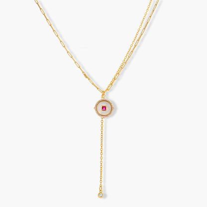 Gold-plated circular medallion necklace set with white enamel base and pink cubic zirconia accent stones