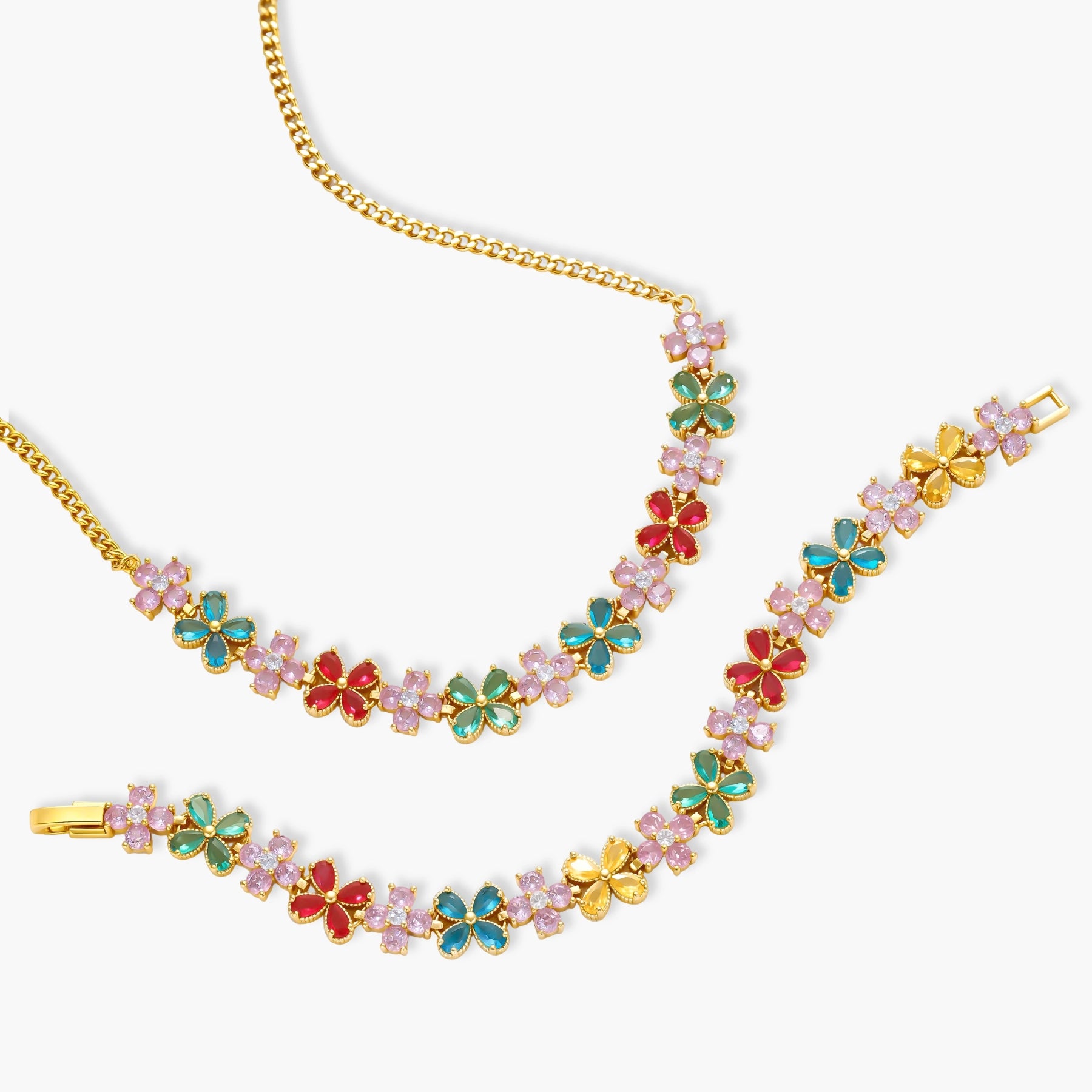 Gold-plated jewelry set with pink, turquoise and red flower-shaped cubic zirconia stones, featuring necklace, earrings and bracelet.