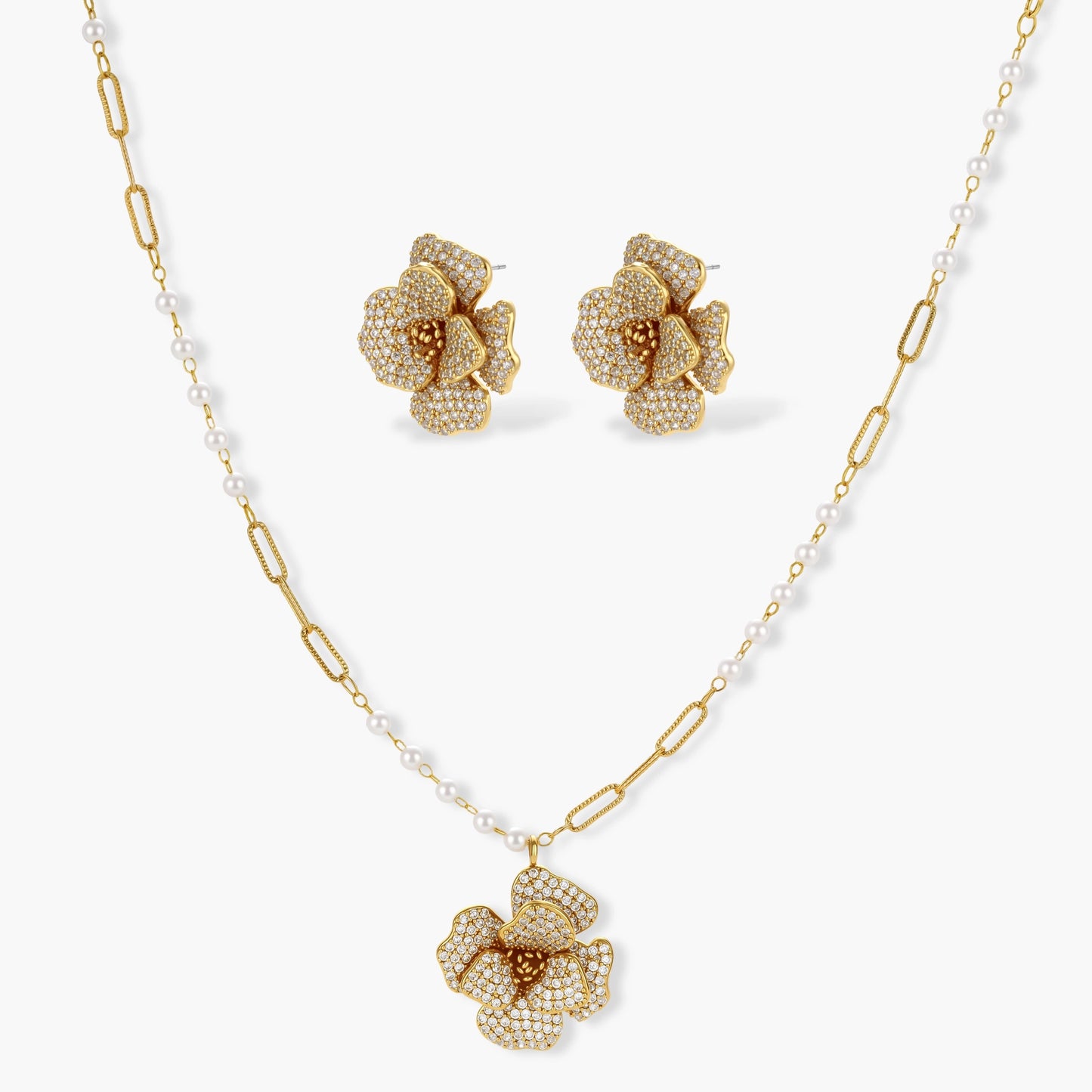 14K gold-plated floral jewelry set with blue cubic zirconia centers and pearl chain details on white background.